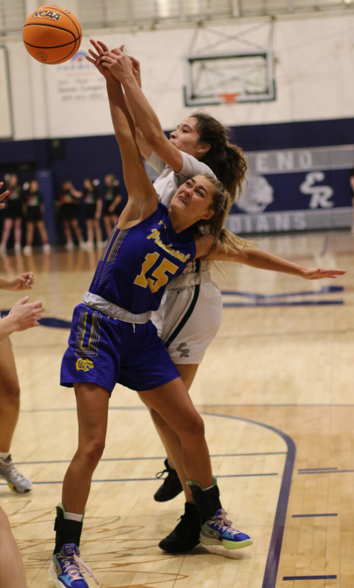 Piedmont's Jillian Crawford battles for a rebound during the first half Friday night. (Photo by Glen Miller/El Reno Tribune